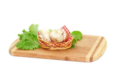 Champignons lying on cutting board Stock Photos