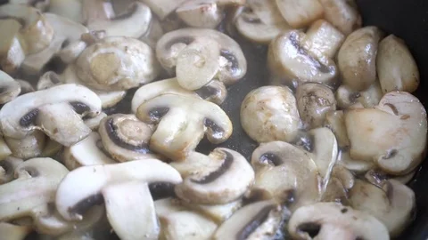 Champingnons being fried in the pan Stock Footage 79724142