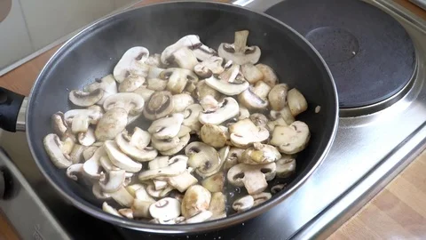 Champingnons being fried in the pan Stock Footage 79725040