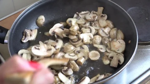 Champingnons being fried in the pan. Timelapse Stock Footage 79728726