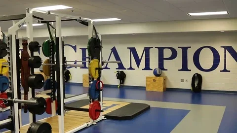 Champion Written on Wall in Background of Weight Training Equipment Stock Footage 69229964