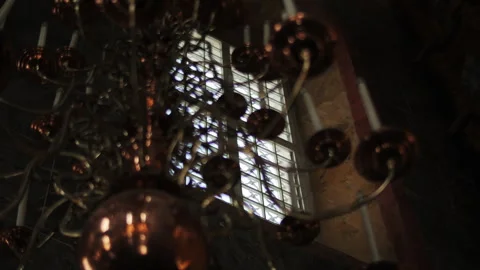 Chandelier and window inside a dark church interior Stock Footage 312512704