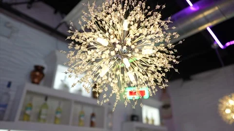 A chandelier hanging from a ceiling in a room Stock Footage 266439404