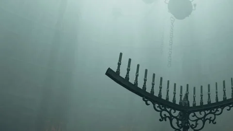 Chandelier hanging in a dimly lit space with fog present above Stock-Footage 344877234
