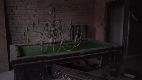 Chandelier on pool billiards table in old abandoned mansion stately home Stock Footage 101354384