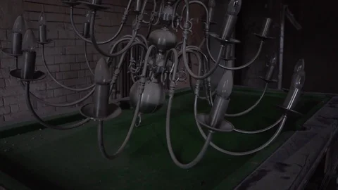 Chandelier on pool billiards table in old abandoned mansion stately home Stock Footage 101354420