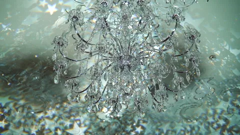 Chandelier rotating of many glass elements that shine by reflecting light. Stock Footage 197482696