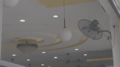 Chandeliers, chandeliers, and a running ceiling fan. Stock Footage 344011189