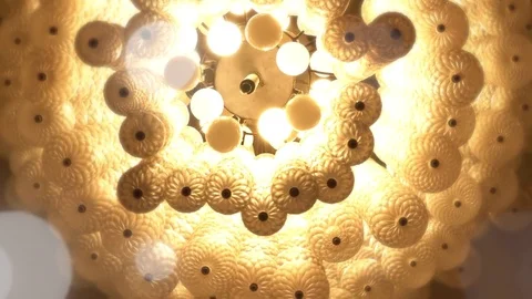 Chandeliers spiral to soft light yellow like a dream. Video stock 81108944