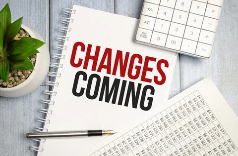 Change is coming text write on paper and calculator on wooden background Stock Photos