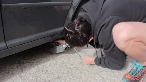 Change a flat car tire Stock Footage 90814367