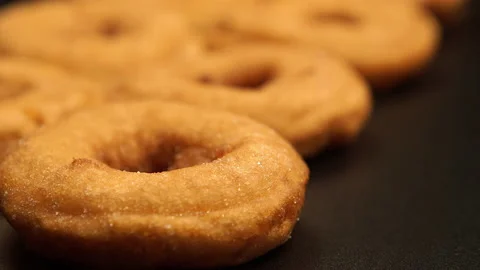 Change of focus along the row of doughnuts Stock Footage 142340217