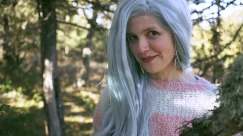 Change of focus from close-up of a branch to young woman with colored hair Stock Footage 102762801