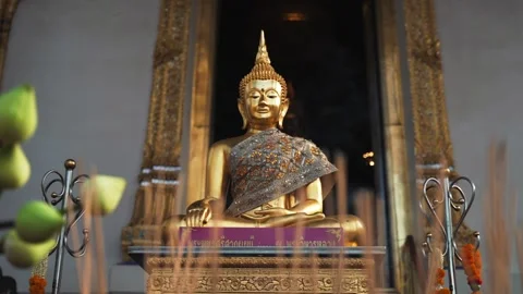 Change focus effect from close up of burning smoke Incense sticks to the Golden Stock Footage 289805072