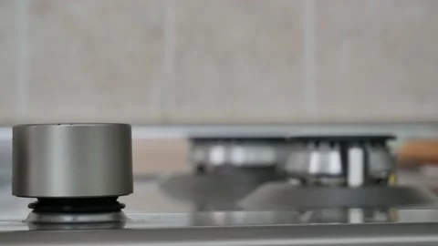 Change of focus of a girl's hand while turning the gas knob. Stock Footage 131854643