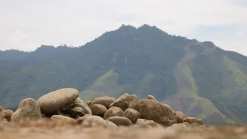 Change of Focus from Pile of Rocks to Uphill Dirt Road Stock Footage 209806429