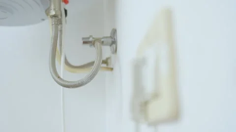 Change of focus, plug plugged in electric socket to water supply hose and Stock Footage 257525754