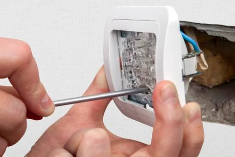 Change light switch, connect the wires from  house wiring. Stock Photos