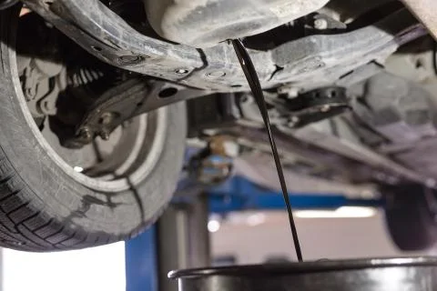 Change the old engine oil for car. Repair service. Stock Photos