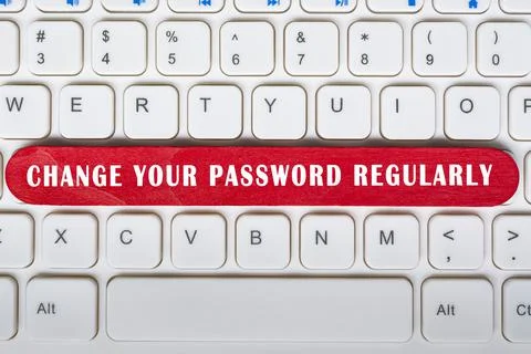 Change your password regularly text on wooden stick placed on laptop or notebook Stock Photos