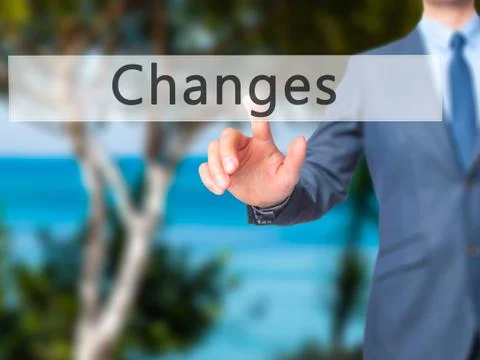 Changes - Businessman hand pressing button on touch screen interface. Stock Photos
