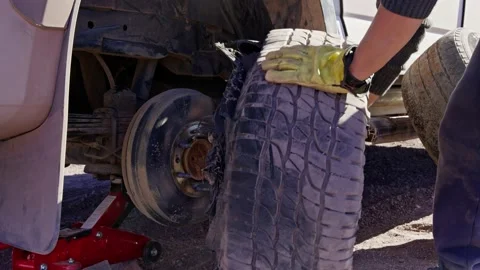 Changing a broken tyre off-roads from a 4x4 vehicle Stock Footage 238628966