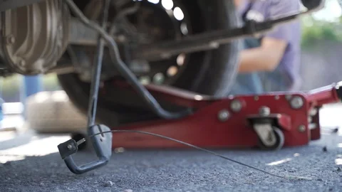 Changing car leaked flat tyre wheel with spare part Video stock 119695029