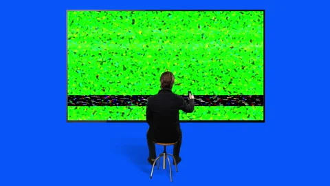 Changing Channels Big Green Screen Television Man Using TV Remote Stock Footage 162233810