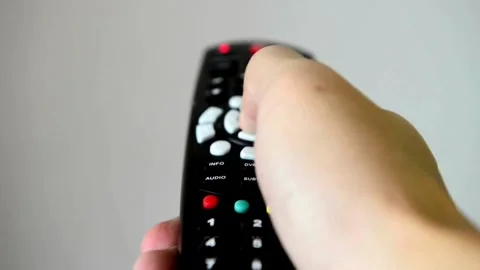 Changing channels on TV. Thumb Pressing Different Channel Numbers on Remote.. Stock Footage 257874204