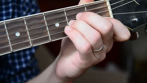 Changing the chords on the guitar close-up Stock Footage 92908891