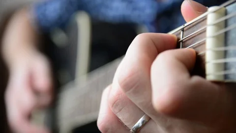Changing the chords on the guitar close-up Stock Footage 92908892