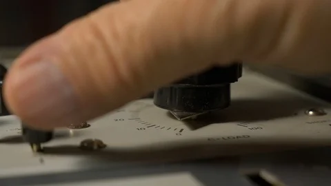 Changing control settings on a vintage electronic device Stock Footage 93531508