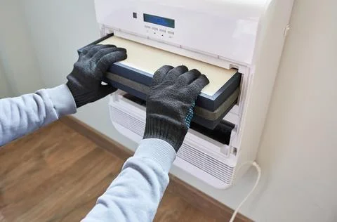 Changing the filter in the air conditioner. Stock Photos