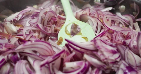 Changing focus Sliced red onion in a frying pan on the stove Stock Footage 302352046
