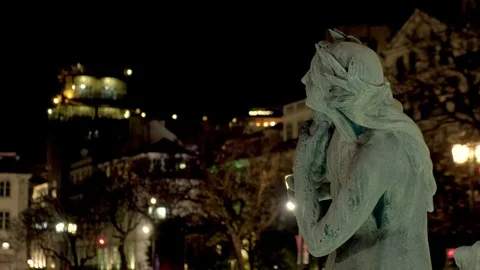 Changing focus from statue at fountain to Elevator de Santa Justa at night Stock Footage 115316300