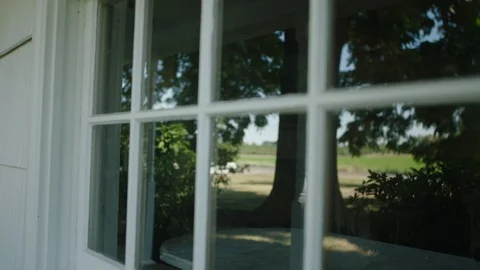 Changing focus from a window to a tree in the reflection Stock Footage 104266511