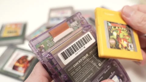 Changing The Game Cassette of a Gameboy Portable Console Stock Footage 263822929