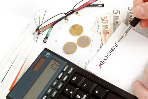 Changing impossible word to possible, calculator, charts, pen in hand, money, Stock Photos