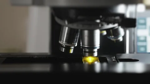 Changing lenses of a fluorescence microscope. Modern microscope. Video stock 294702401