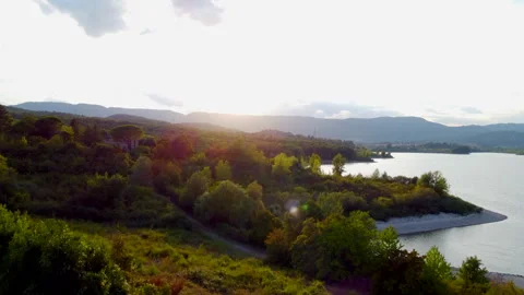 Changing light over tuscan lake and countryside Stock Footage 320845636