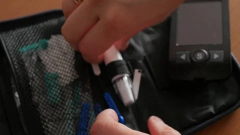 Changing needle, lancet in automatic lancing device, glucose Stock Footage 102133239