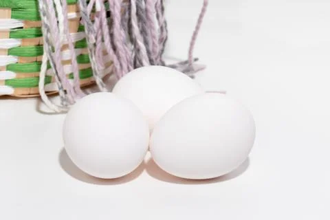 Changing seasons from winter to spring, easter white chicken eggs and a green Stock Photos