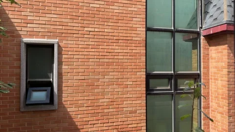 Changing Sunlight and Shadow Contrast on Orange Brick Building Facade Video stock 347301673