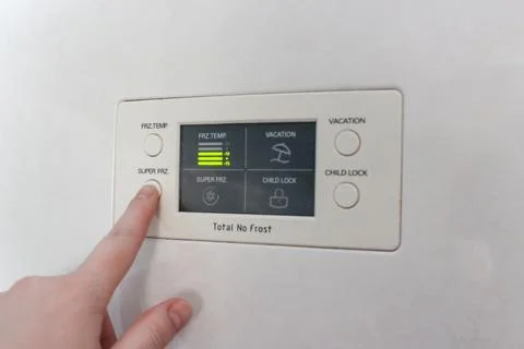 Changing temperature on a smart fridge screen at home Foto stock