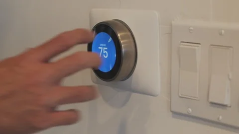 Changing the temperature on a smart thermostat. Stock Footage 114733166