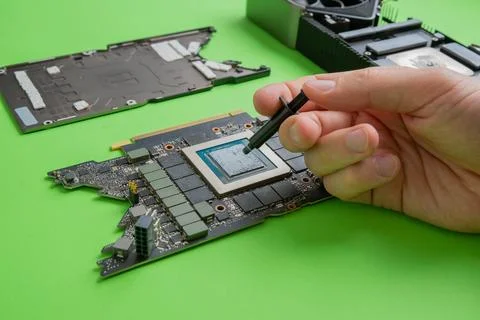 Changing the thermal paste on the graphics processor. Disassembled graphics c Stock Photos