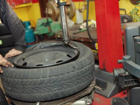 Changing a tire in a garage Stock Photos