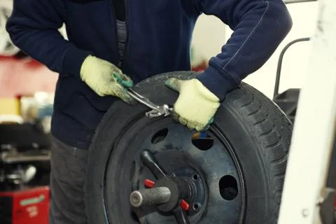 Changing a tire in a garage Stock Photos