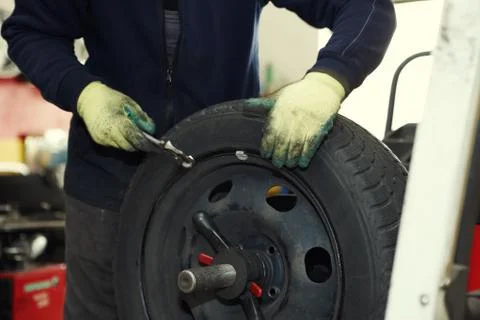 Changing a tire in a garage Stock Photos