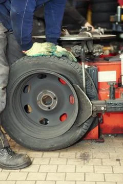 Changing a tire in a garage Stock Photos